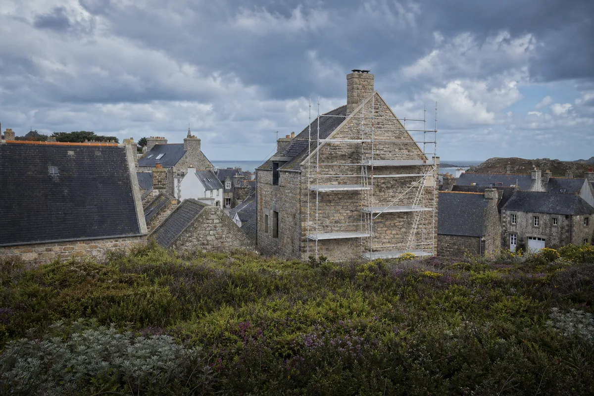 Toiture en ardoise d'une maison bretonne vue de trois quarts sous un ciel couvert